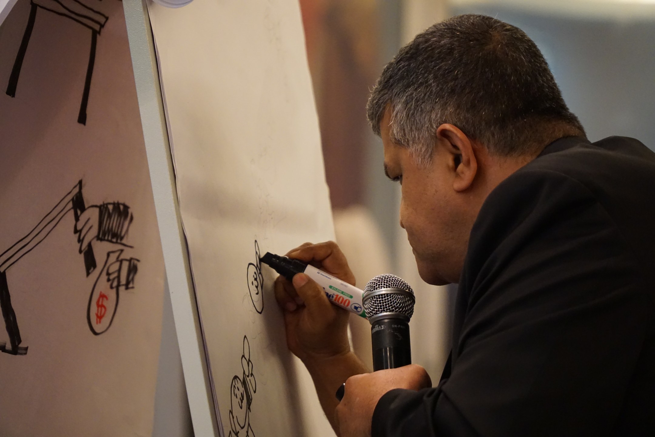 Zulkiflee Anwar Haque with live drawing at an event forum titled "Kleptocrazy Malaysia: Declare Your Assets Now! on May 12, 2017