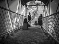Malaysian children sitting on stairs waiting for bus, near SS13, Subang Jaya